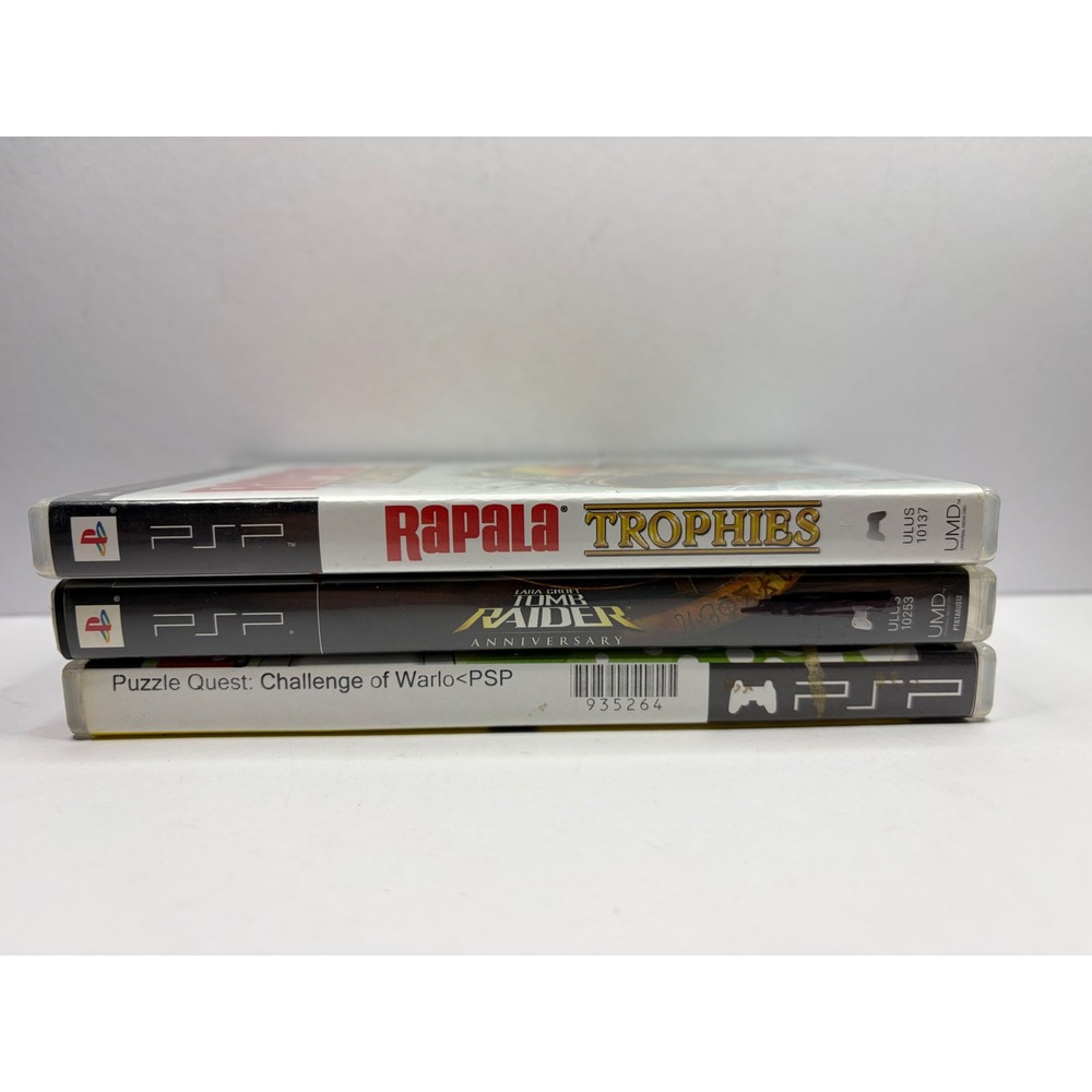 Sony PSP 3 Game Lot Tomb Raider Anniversary Rapala Trophies Puzzle Quest UMD
